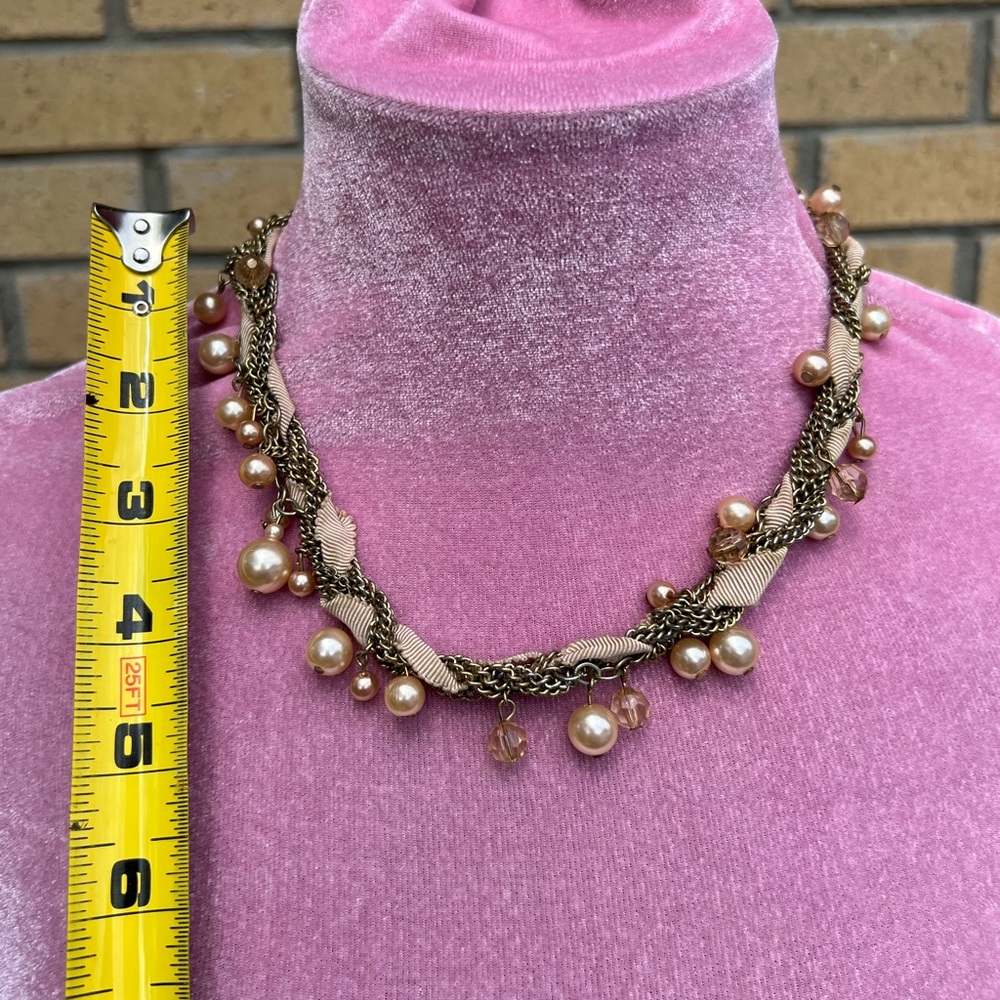 Nude pearl necklace.